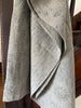 Textured gray fabric draped over a wooden surface