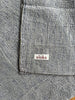 Gray textured blanket with 'aloka' label