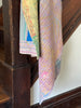 Colorful patterned fabric draped over a wooden staircase