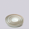 Set of three ceramic bowls with gold rims on a light gray background