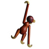 Wooden monkey figure with a banana on a white background