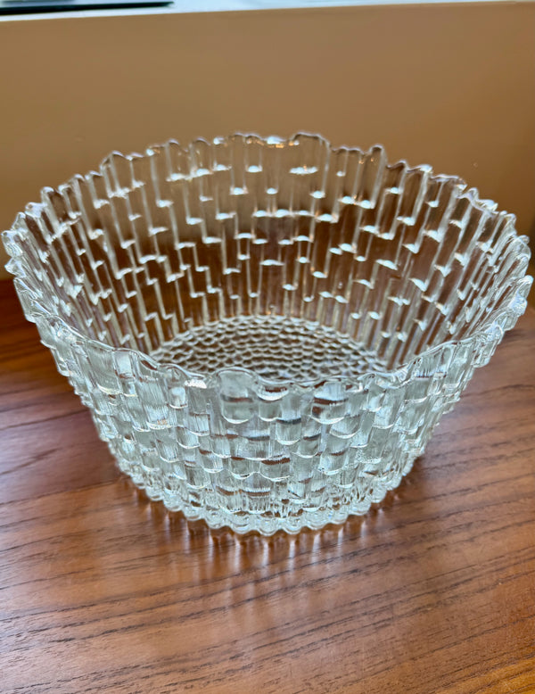 Clear glass bowl with textured design on a wooden surface