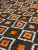 Close-up of a patterned vintage rug with geometric design