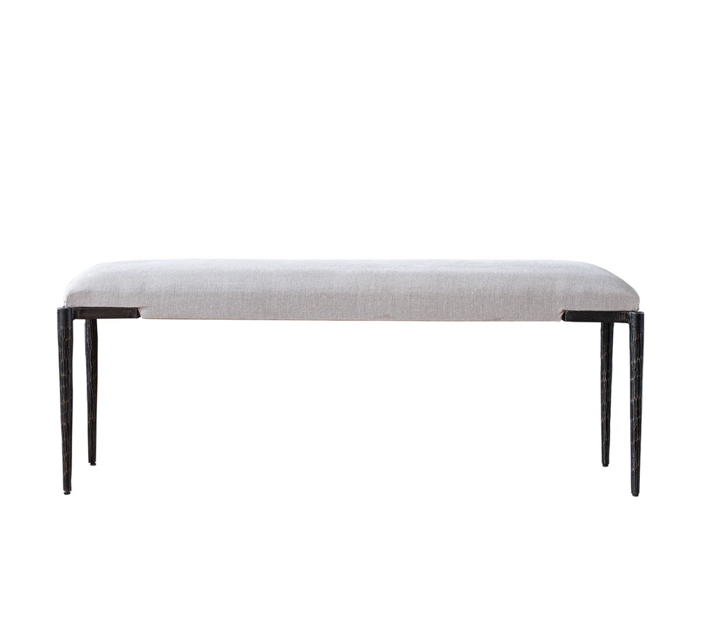 Light gray upholstered bench with dark metal legs on a white background