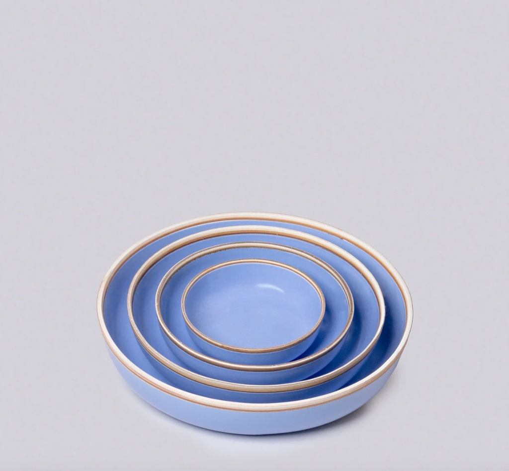 Set of three blue ceramic bowls with raw natural clay rims