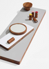 Wooden hooks and mirror on a white surface