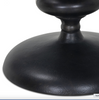 Close-up of a black metal side table base on a white background