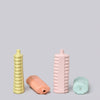 Four colorful ribbed bottles on a light gray background