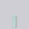 Light blue textured bottle on a light gray background