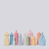 Set of colorful ceramic bottles on a light gray background