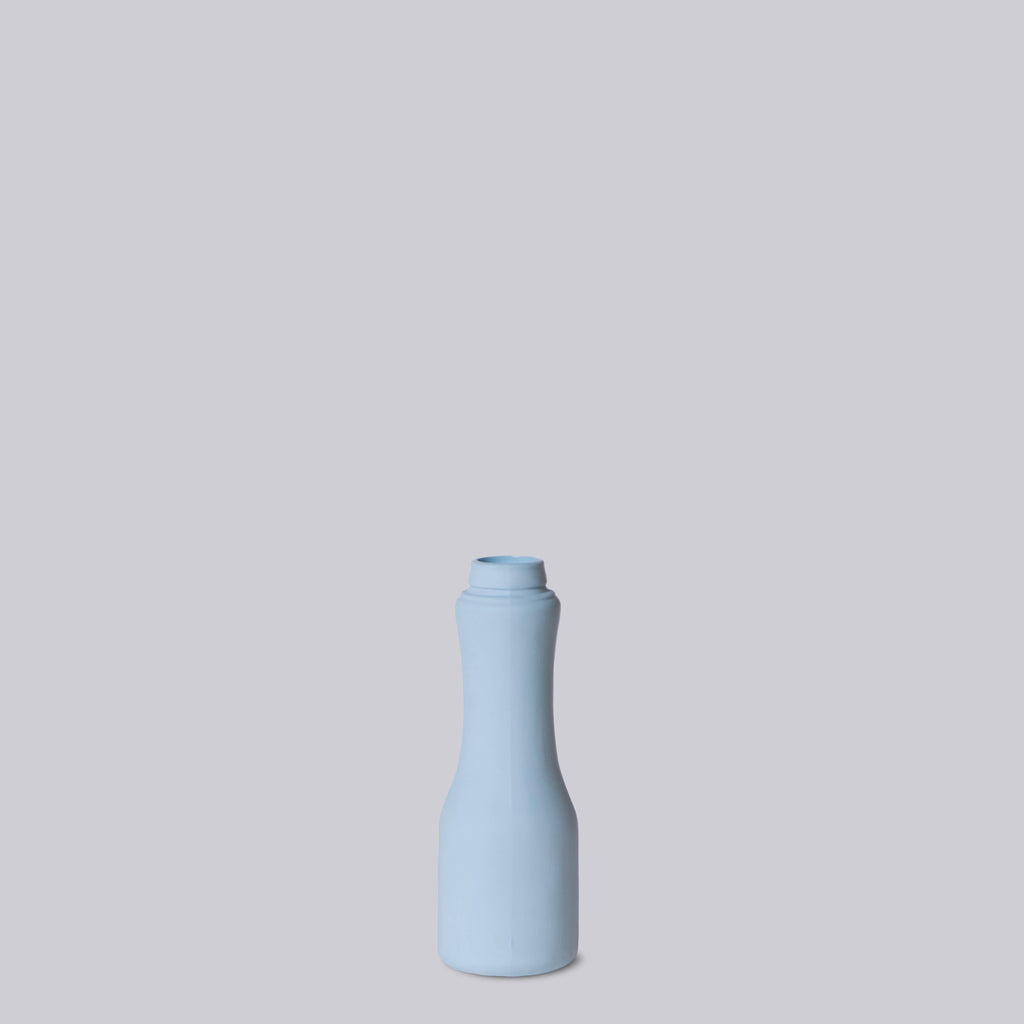 Light blue ceramic bottle on a light gray background
