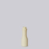 Beige and light yellow ceramic bottle on a light gray background