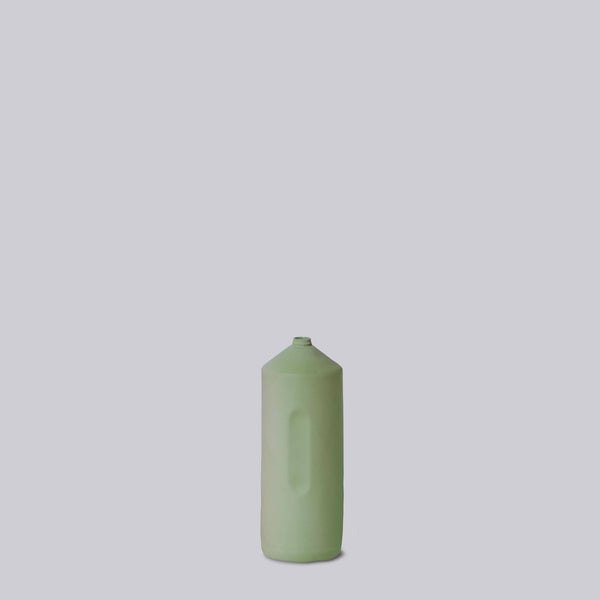 Tall cylindrical product with rose gold top and black textured bottom on white background