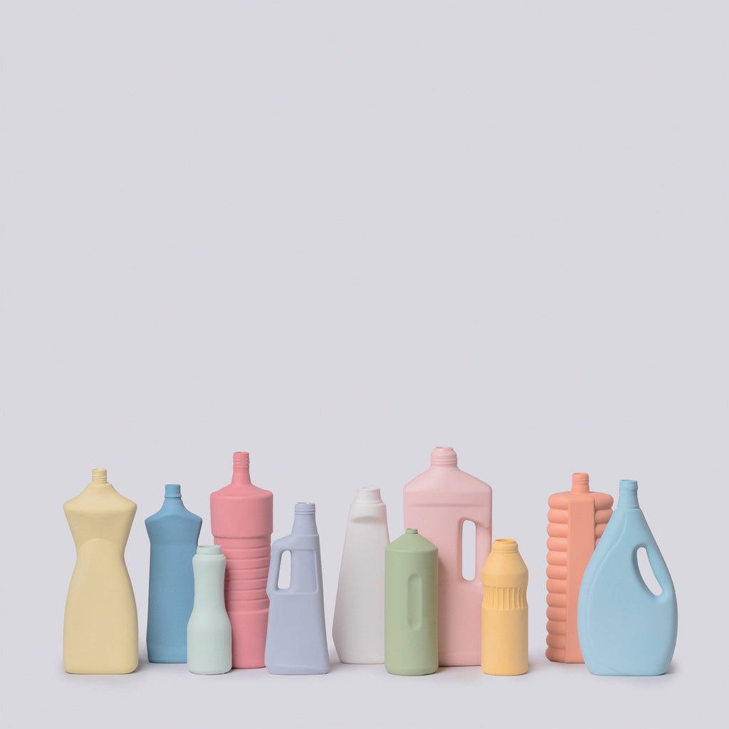 Set of colorful ceramic bottle vases on a light gray background
