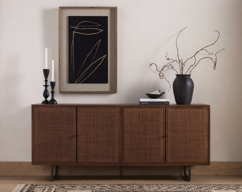 Wooden sideboard with decorative items in a room setting