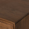Close-up of a wooden cabinet with wicker texture