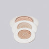 Set of three wooden coasters with white rims on a light gray background