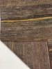 Close-up of a textured brown rug with a yellow line on a white background