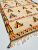 Close-up of a patterned rug with geometric designs on a light background