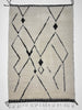 Geometric patterned rug with black lines on a light background