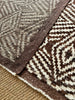 Close-up of a brown and beige patterned rug
