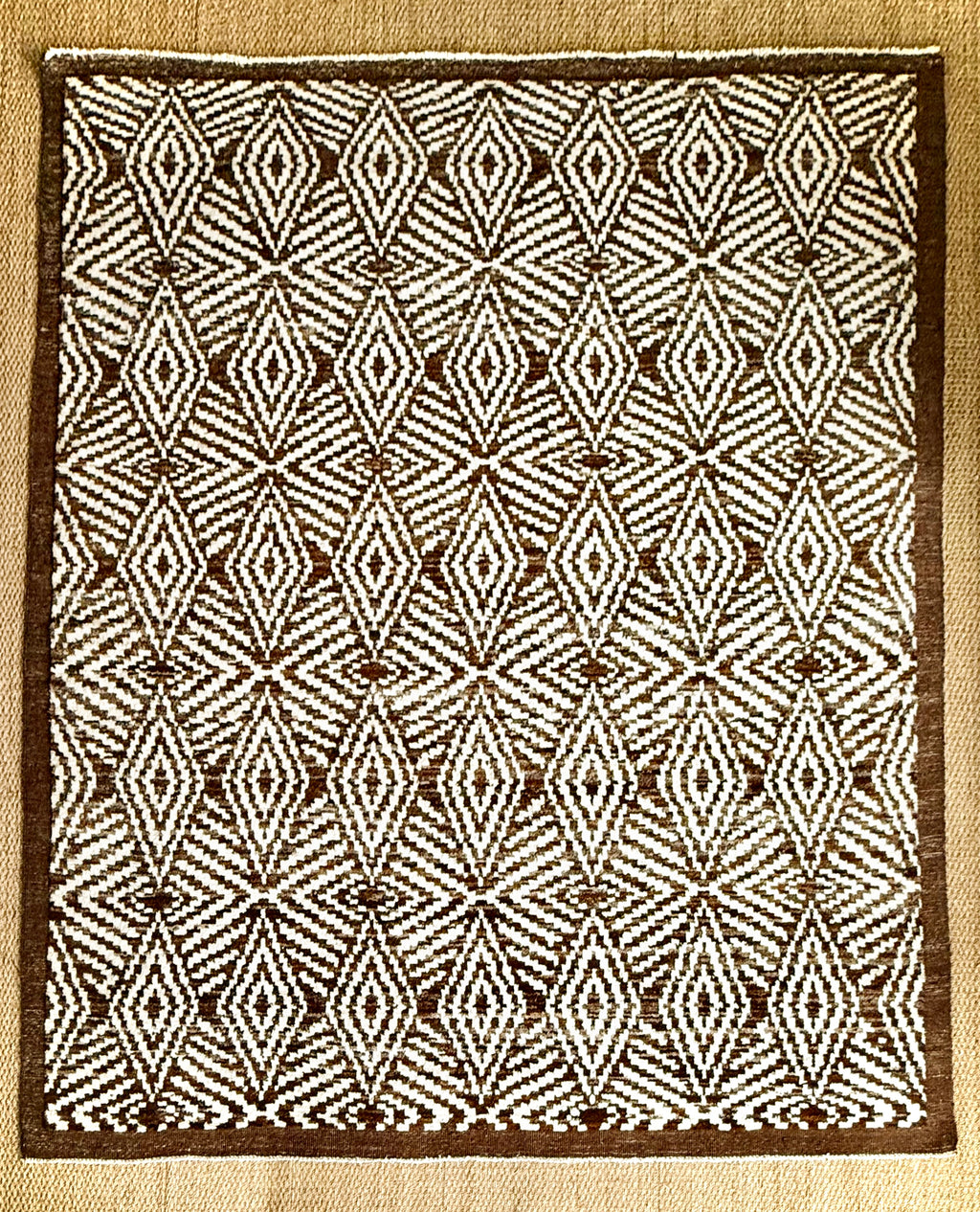 Rug with diamond pattern on a beige background