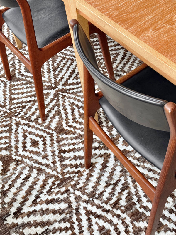 Dining table with chairs on a patterned rug