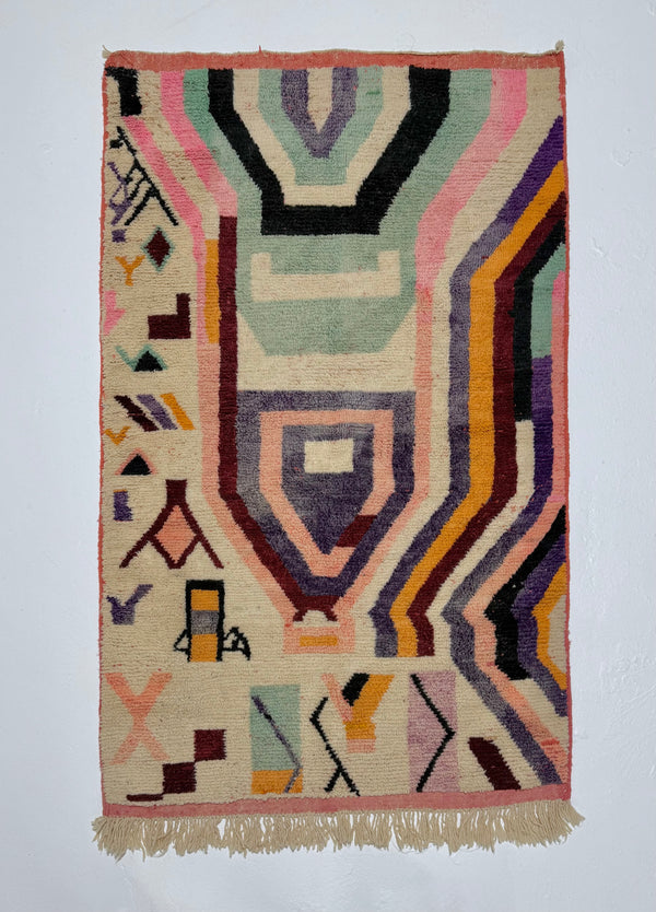 Geometric patterned rug with multicolor design on a plain background