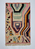 Geometric patterned rug with multicolor design on a plain background