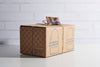 Cardboard box with 'Moroccan Glassware' branding on a white surface.
