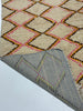 Close-up of two patterned rugs with geometric designs on a light background