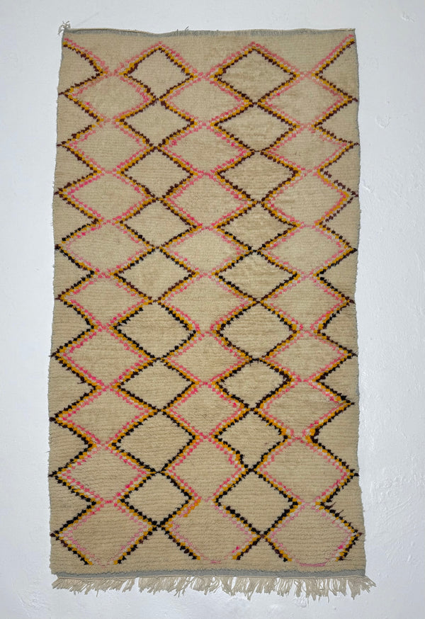 Woven rug with diamond pattern on a plain background