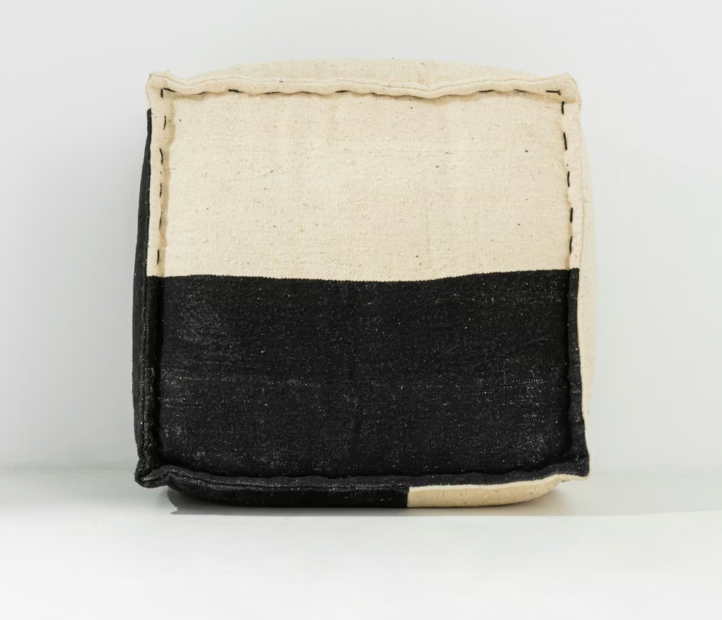 Black and beige woven basket on a white background