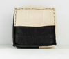 Black and beige woven basket on a white background