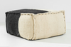 Oversized pouf in white and black fabric. large stitching