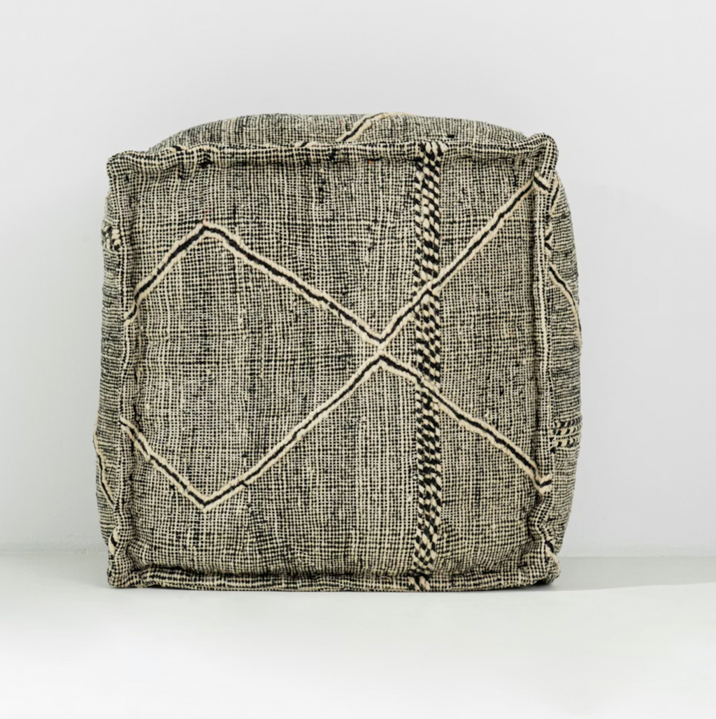 Textured fabric basket with geometric pattern on a white background