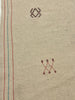 Textile with embroidered patterns on a beige background