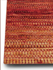 Textured red and brown patterned fabric on a white background