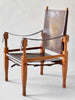 Wooden chair with brown leather seat and backrest on a white background