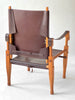 Brown leather chair with wooden frame on a white background