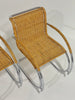 Wicker chair with metal frame on a plain background