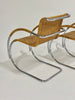 Woven chair with metal frame on a plain background