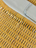 Close-up of a wicker chair with a metal frame on a white background