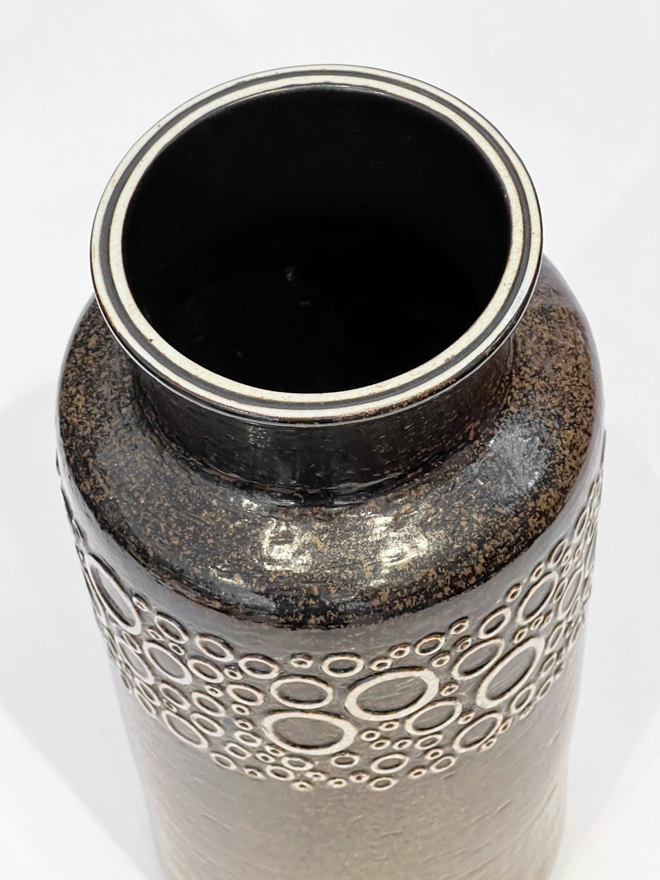 Ceramic vase with textured design on a white background