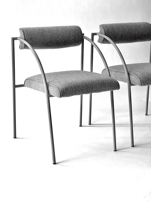 Two gray chairs with metal frames on a white background