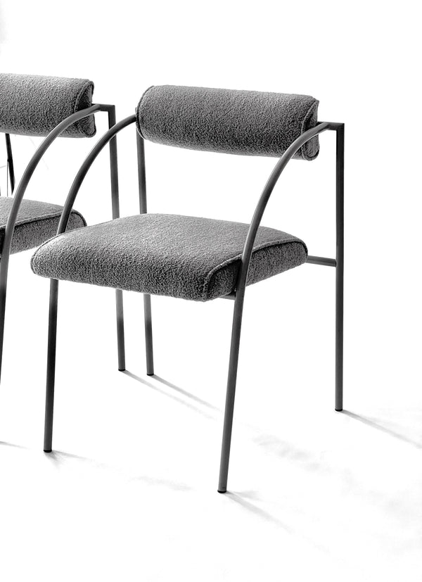 Gray upholstered chair with metal frame on a white background