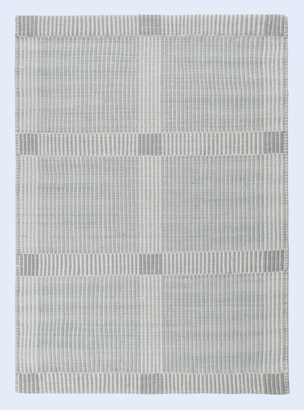 Rectangular rug with a striped pattern on a light blue background