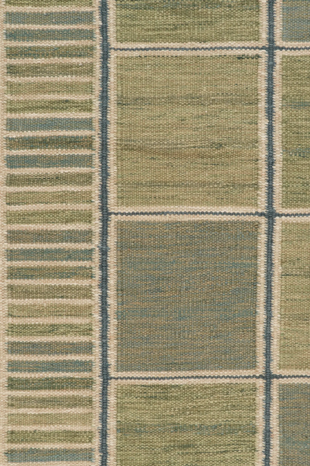 Textured rug with a pattern of squares and stripes in green and beige tones.