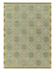 Patterned rug with geometric design in green and beige tones