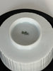 Close-up of a white ceramic product with a visible brand logo on a black background